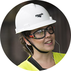 female employee in PPE smiling